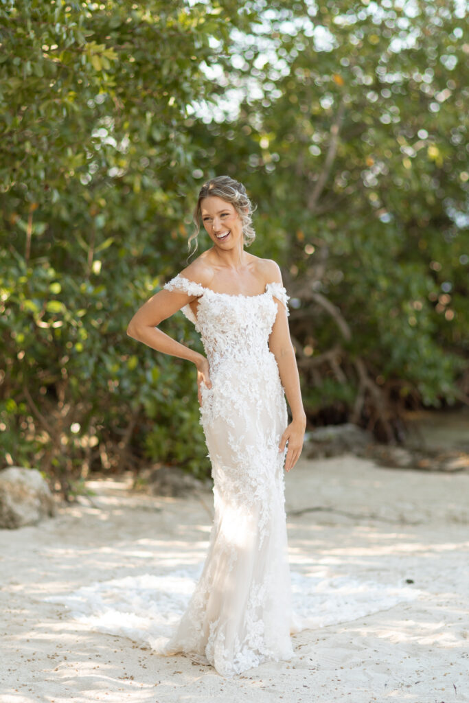 Bride in her gown with lush tropical greenery in the background