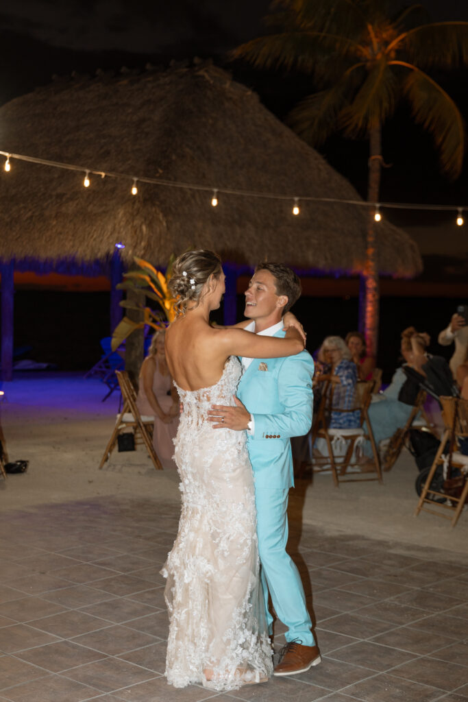 Romantic first dance under the stars at The Reefhouse Resort in Key Largo, with the ocean gently glowing in the background, captured by The Deans Photography.