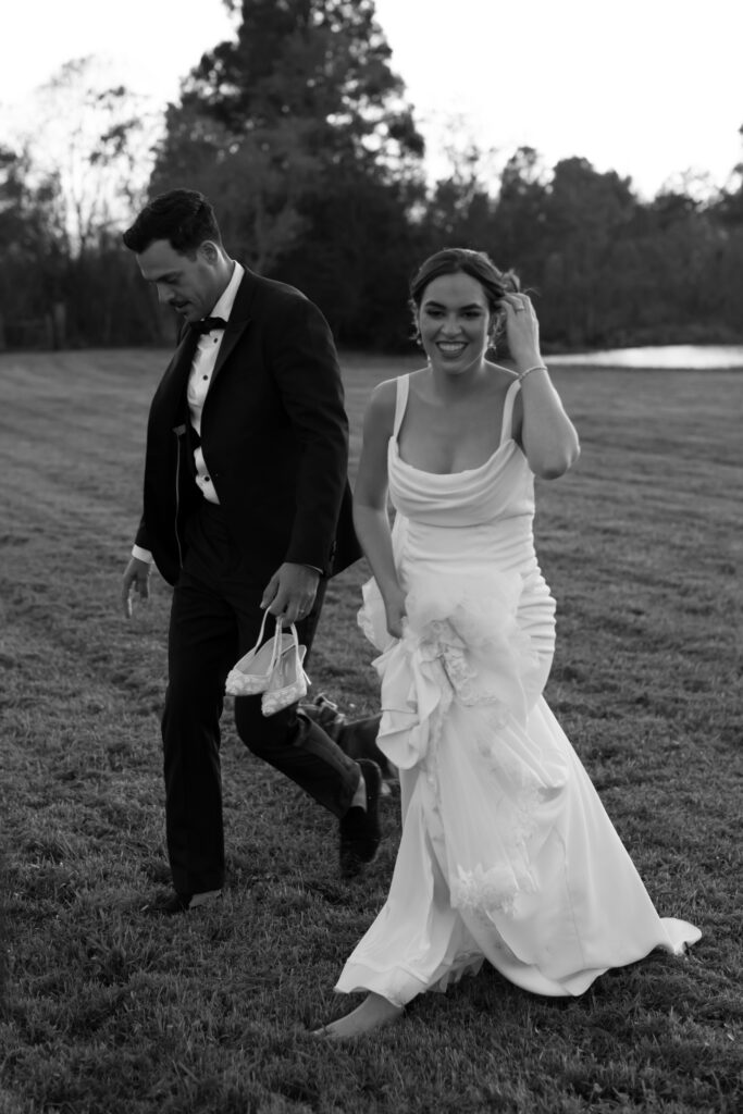 Romantic sunset portrait at Lavender on the Lake, photographed by The Deans Photography, with the bride and groom framed by lavender fields and a glowing sunset over the water.