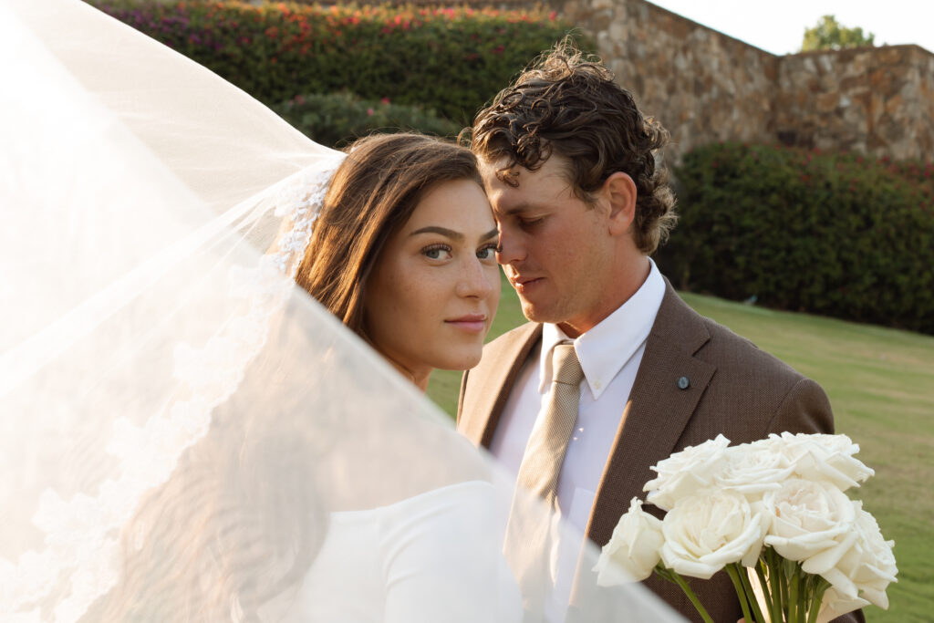 Bride and groom captured by The Deans Photography at Bella Collina, with the stunning Tuscan-style architecture and panoramic countryside in the background.