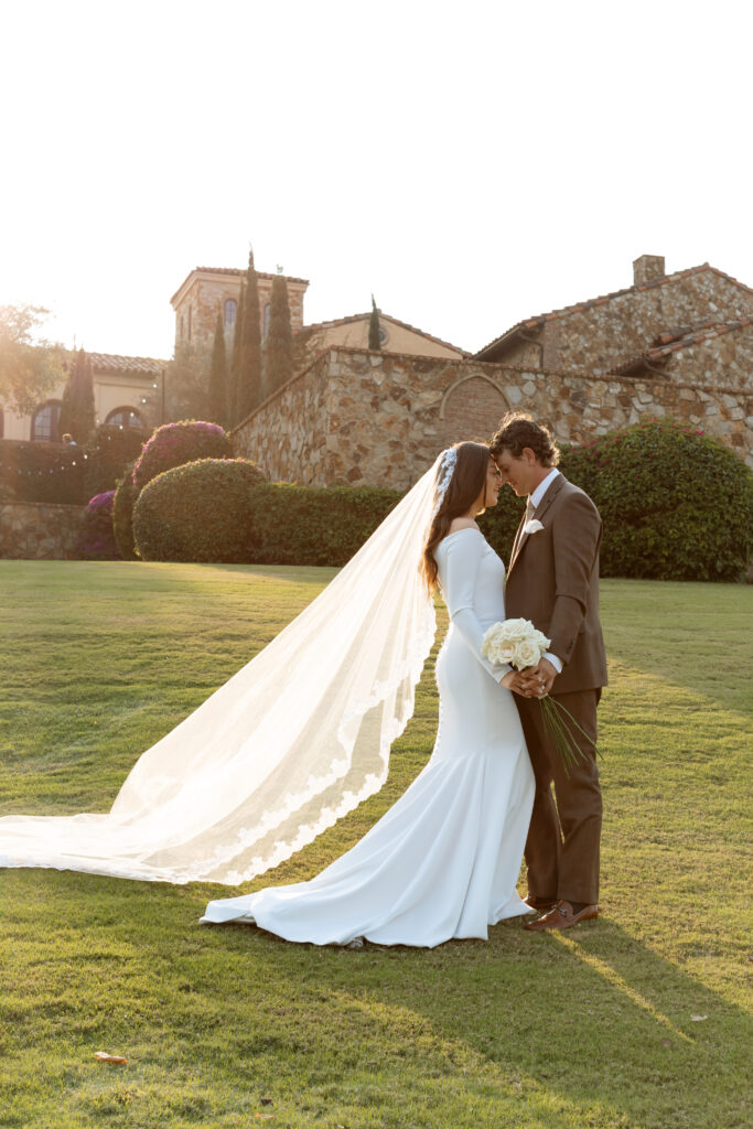 Bride and groom during sunset at Bella Collina, captured by The Deans Photography, with the sun setting over the picturesque hills and Tuscan architecture.