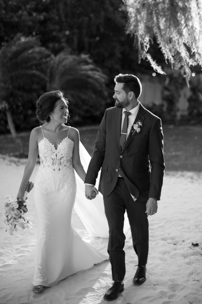 Bride and groom captured by The Deans Photography at Paradise Cove, with a stunning backdrop of Lake Buena Vista and tropical palm trees surrounding them.