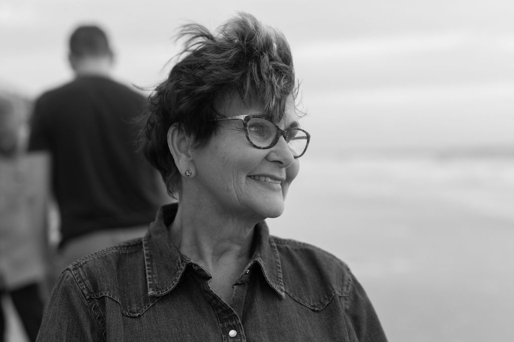 Candid photo of grandma on Melbourne Beach during sunrise, enjoying the beach