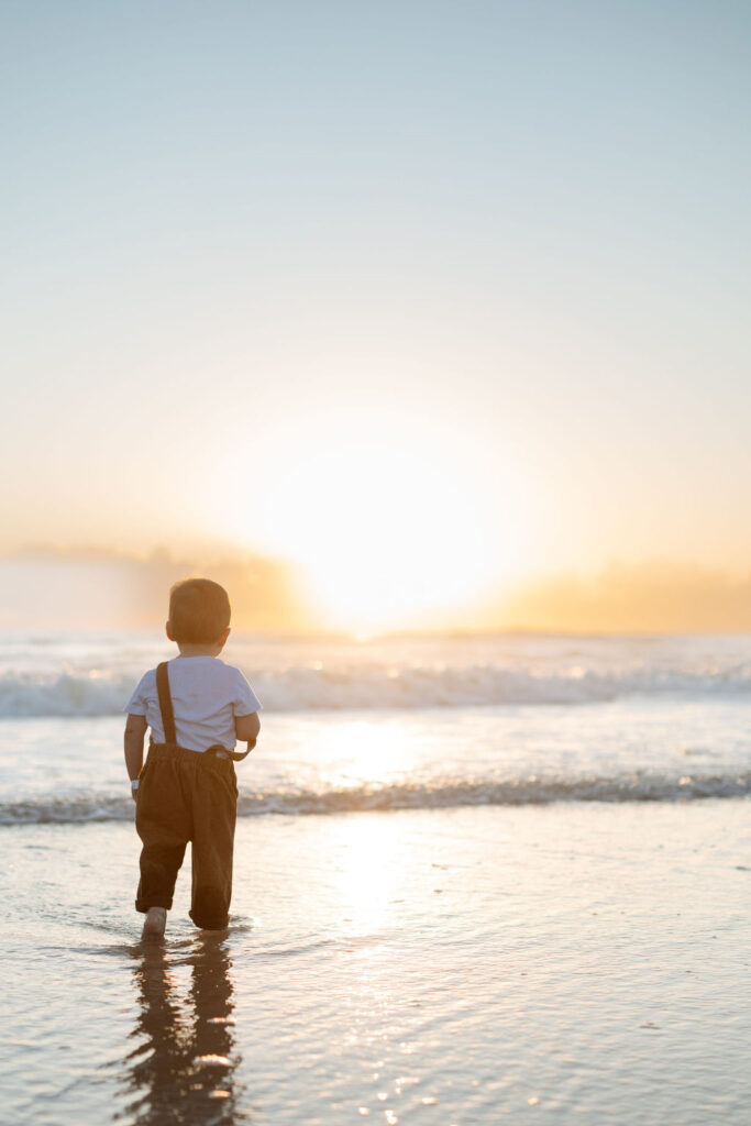 Toddler playing in the ocean in Cocoa Beach during a family photo session. 