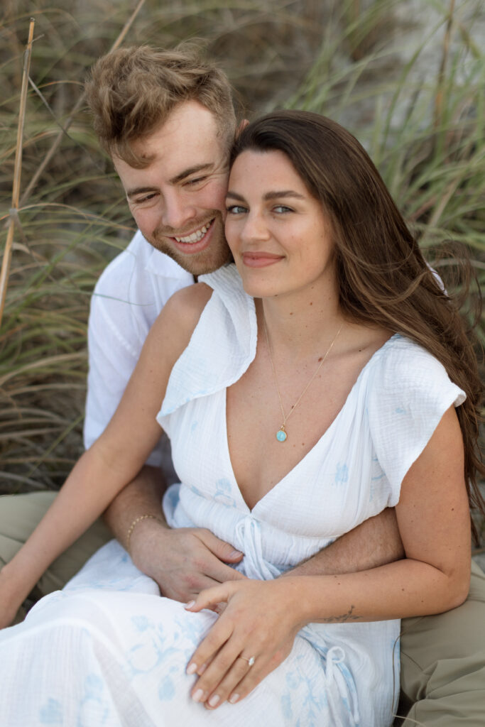 Romantic close-up of couple embracing on Cocoa Beach at sunset, photographed by The Deans Photo, showcasing love and natural beauty.