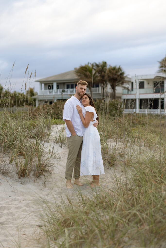 Candid photo of couple laughing on Cocoa Beach at sunset, captured naturally by The Deans Photography during golden hour.