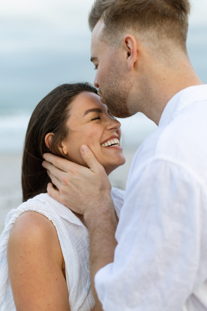 Fun and playful engagement photo of couple laughing.