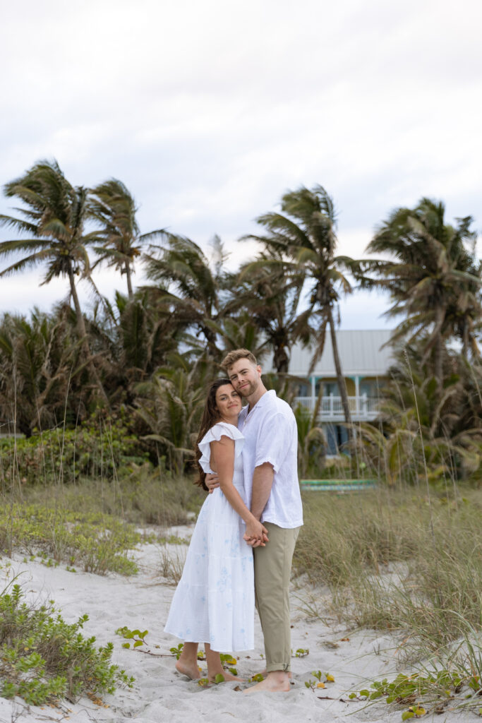 Candid photo of couple laughing on Cocoa Beach at sunset, captured naturally by The Deans Photography during golden hour.