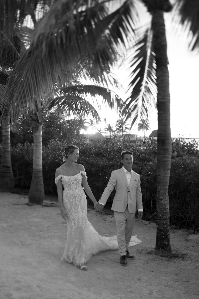 Couple walking by the ocean at sunset in Key Largo, Florida photographed by The Deans Photography.