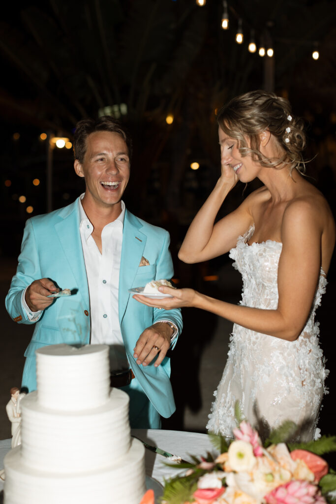 Couple cutting their wedding cake in Key Largo, Florida photographed by The Deans Photography.