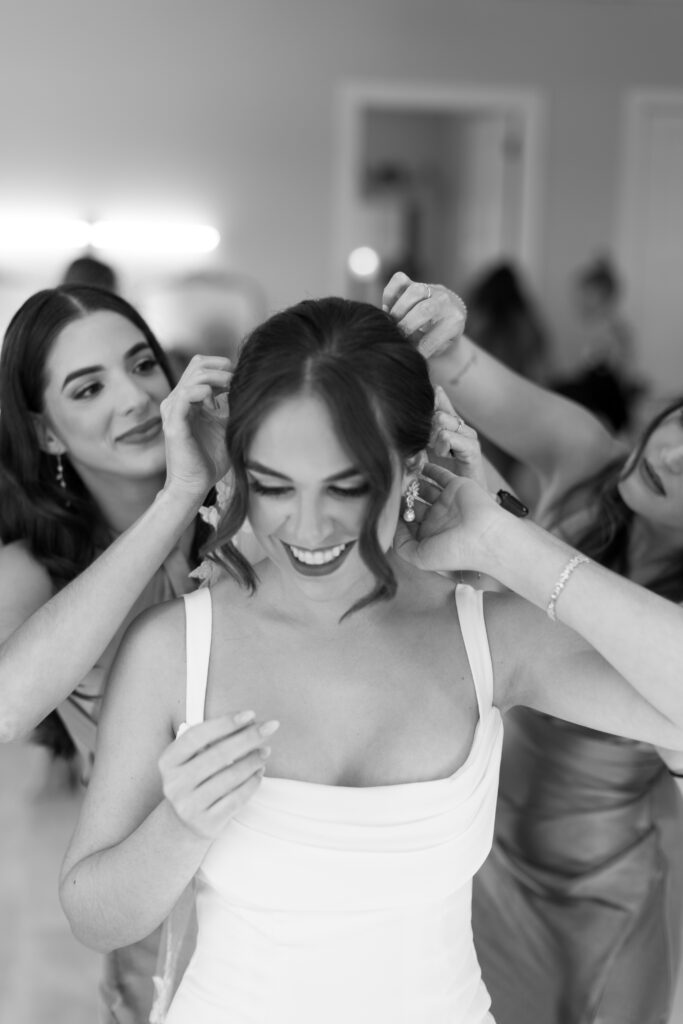 Bride with her best friends in bridal suite at Lavender on the Lake, photographed by The Deans Photography