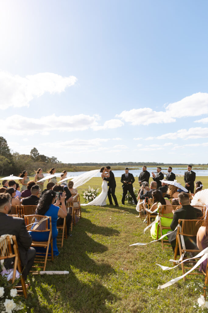 Couple at their lakeside ceremony in St. Cloud, Florida. photographed by The Deans Photography