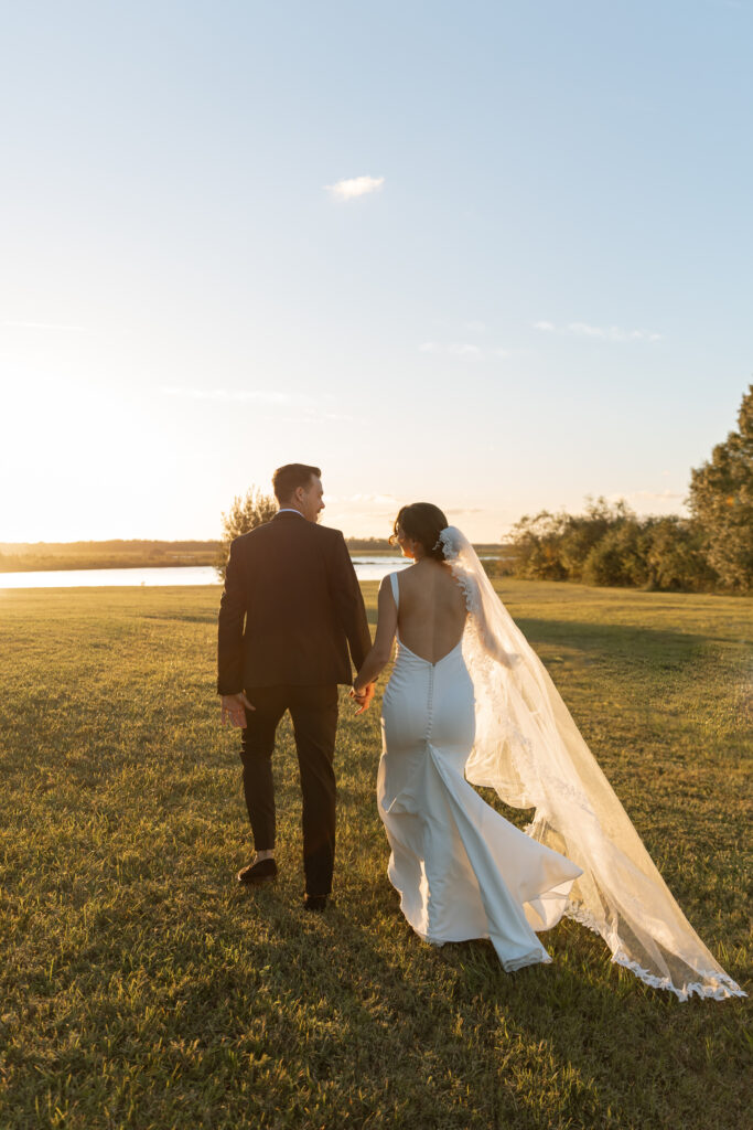 Couple walking towards the lake at sunset in Orlando, Florida at Lavender on the Lake