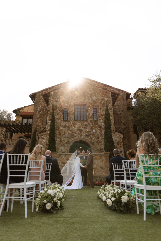 Photograph of couple at their Tuscany style wedding ceremony photographed by The Deans Photography.