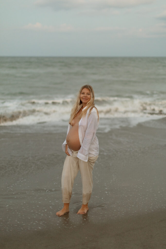 Expecting mother enjoying maternity photoshoot outdoors during golden hour in Central Florida, photographed by The Deans Photography