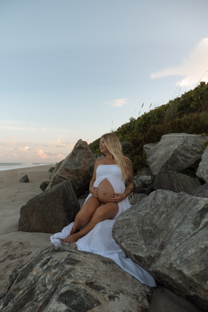 Expecting mother enjoying the sunset during her maternity photoshoot photographed by The Deans Photography.