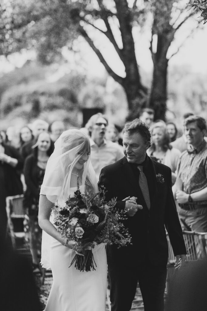 Bride and father walking down the aisle at Tree House Vero Beach, Florida.