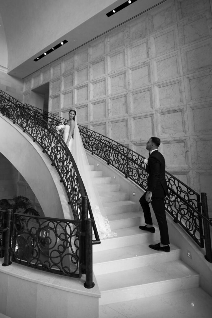 Photo of couple standing on the luxurious staircase at the four seasons in Orlando, Florida.