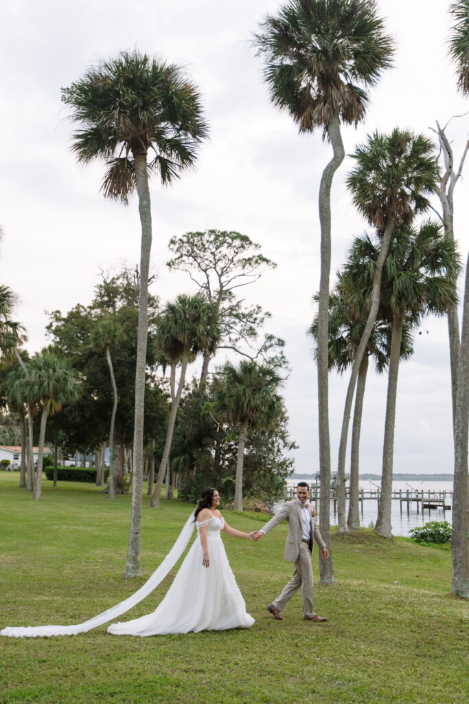 Couple walking towards the river at sunset in Merritt Island, Florida