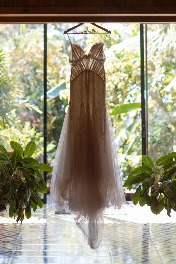 Close-up of wedding details including bride’s dress, shoes, and rings, captured at a destination wedding in Costa Rica by The Deans Photography.