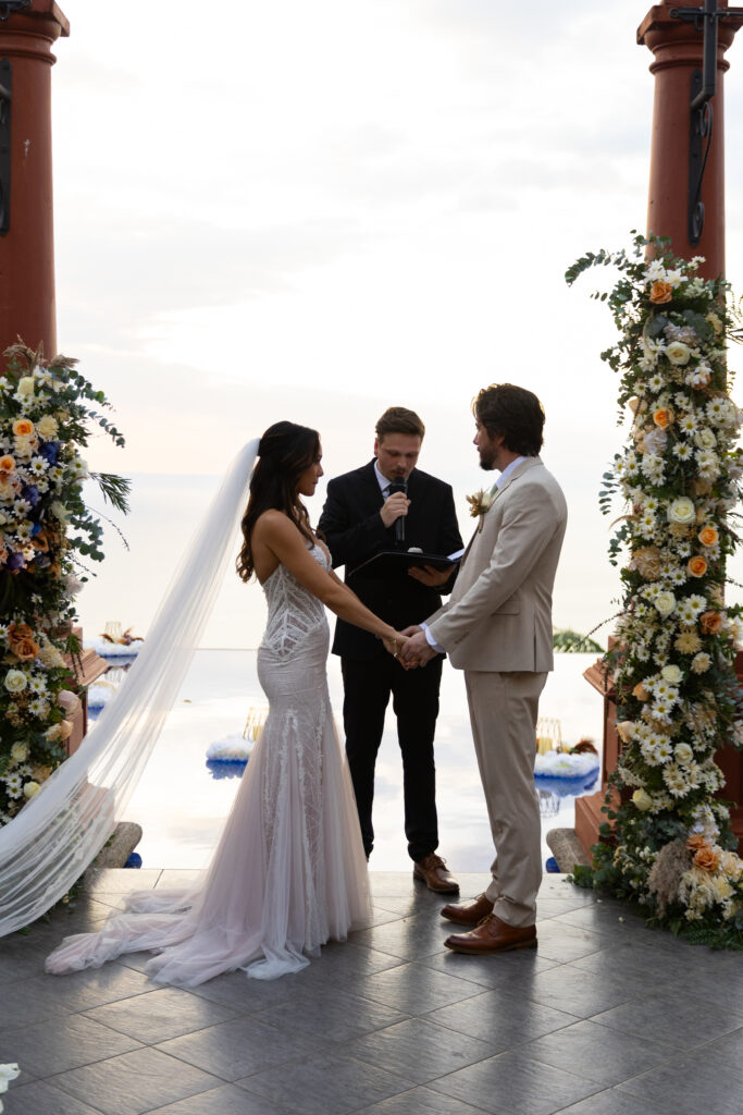 Elegant wedding ceremony setup with tropical flowers and ocean backdrop at Villa Caletas, Costa Rica, photographed by The Deans Photography.