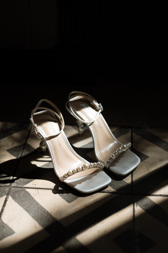 Close-up of wedding details including bride’s dress, shoes, and rings, captured at a destination wedding in Costa Rica by The Deans Photography.