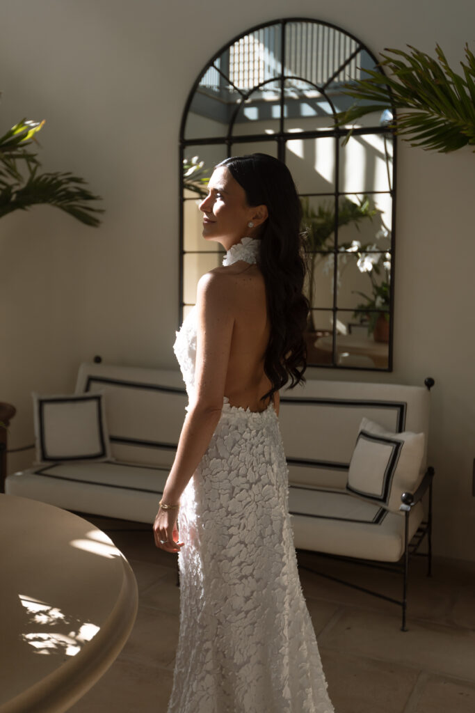 Bride getting ready in natural light at the Vero Beach Hotel, wearing a sleek gown for her intimate Florida elopement