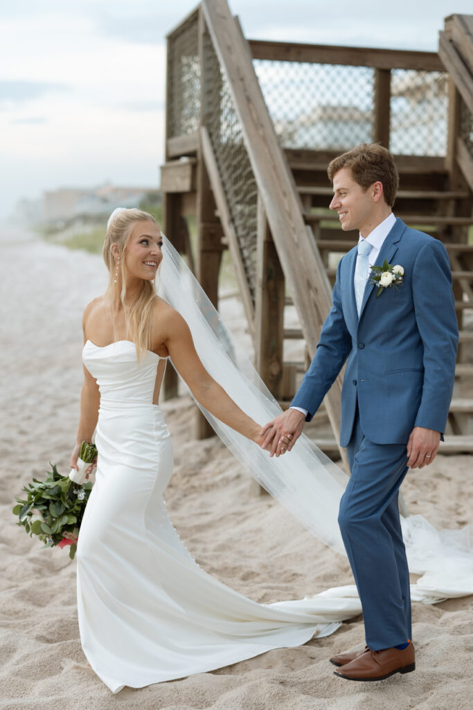 seaside wedding creative photo of couple holding hands