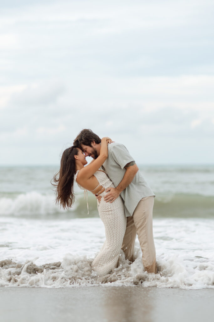 Romantic barefoot engagement session at golden hour on the beach in Central Florida