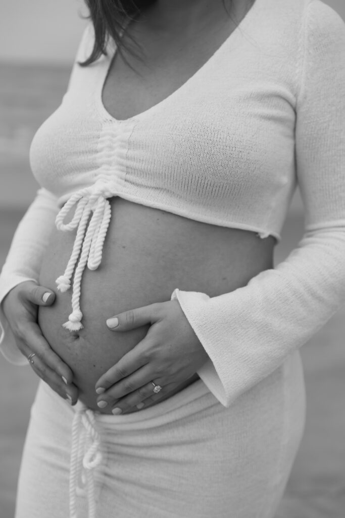 Neutral maternity outfit with flowy dress styled for a beach session in Central Florida