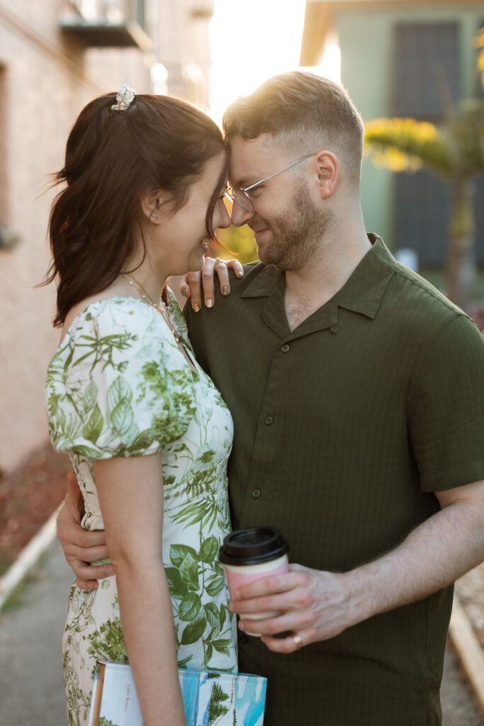 Couple walking hand-in-hand through Downtown Sanford’s historic streets during their engagement session.