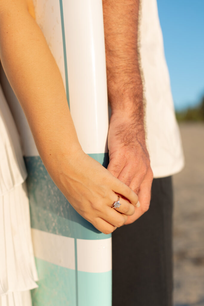 Couple holding hands during their engagement session in Cocoa Beach, Florida
