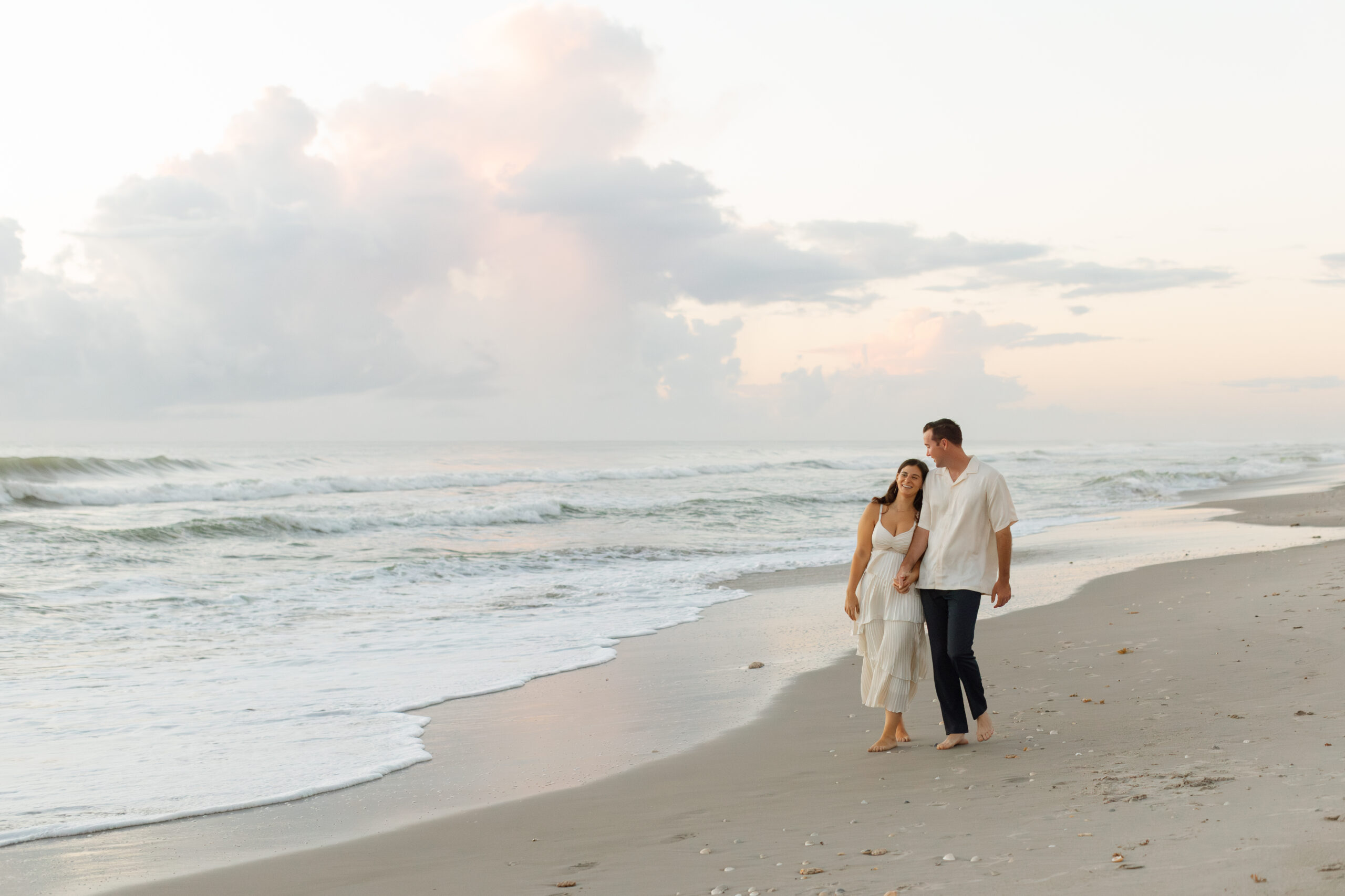 Romantic barefoot engagement session at golden hour on the beach in Central Florida