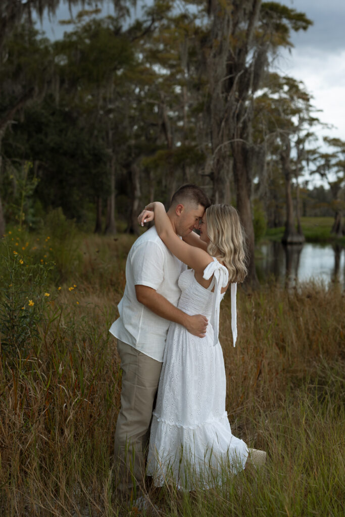 Couple embracing during sunset at Lake Louisa engagement session.