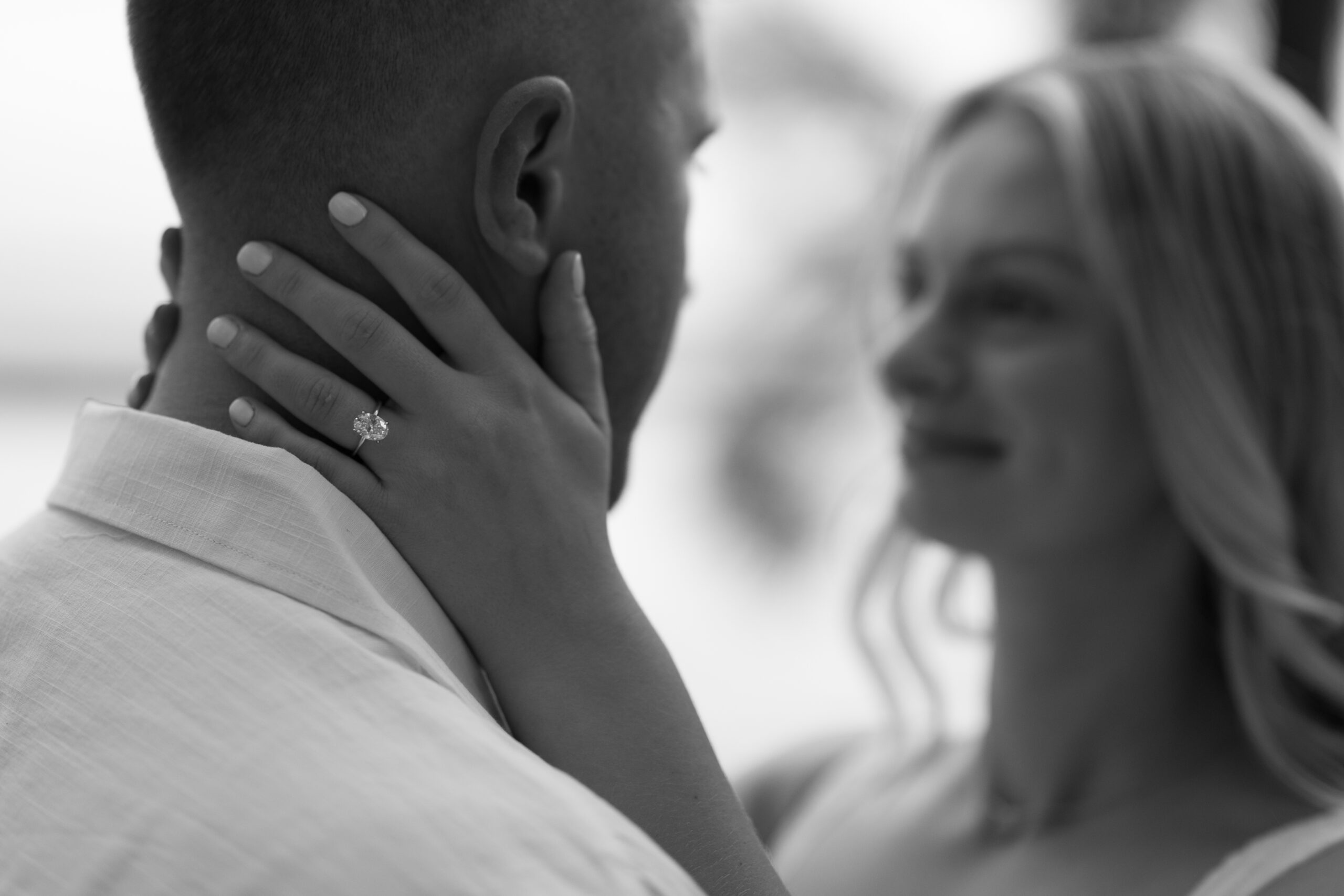 Couple embracing in a golden field at Lake Louisa State Park engagement session in Central Florida.